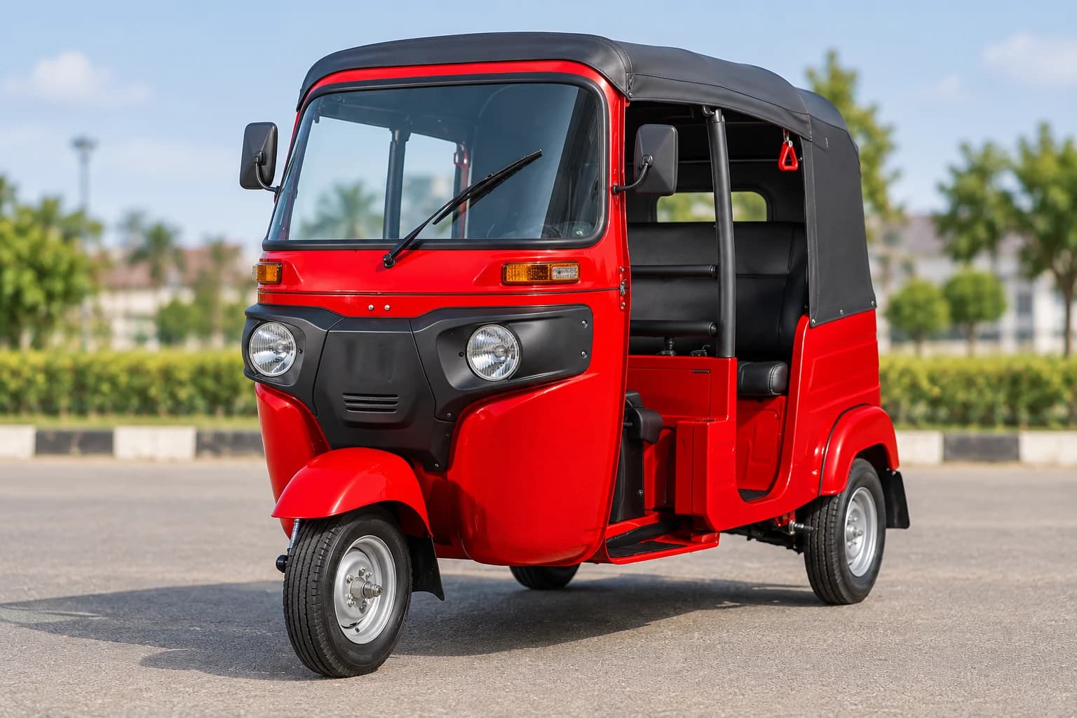 Red passenger tricycle with a black canopy parked outdoors
