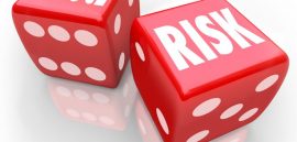 Reduce Risk words on two red dice to illustrate lowering your chances for liability, danger, hazard or exposure while increasing safety and security
